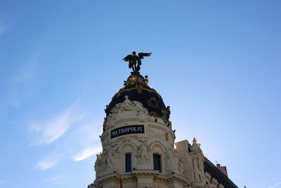 Low angle view of statue of liberty against blue sky