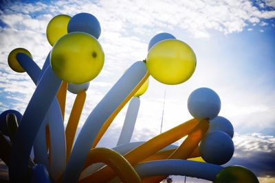 Low angle view of balloons against sky