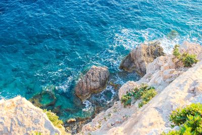 High angle view of rocks in sea