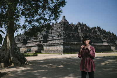 Portrait of woman standing against temple