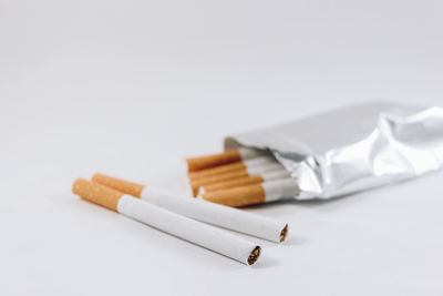 Close-up of cigarette against white background