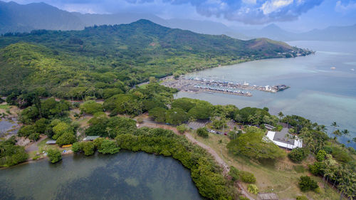 High angle view of sea and mountains against sky