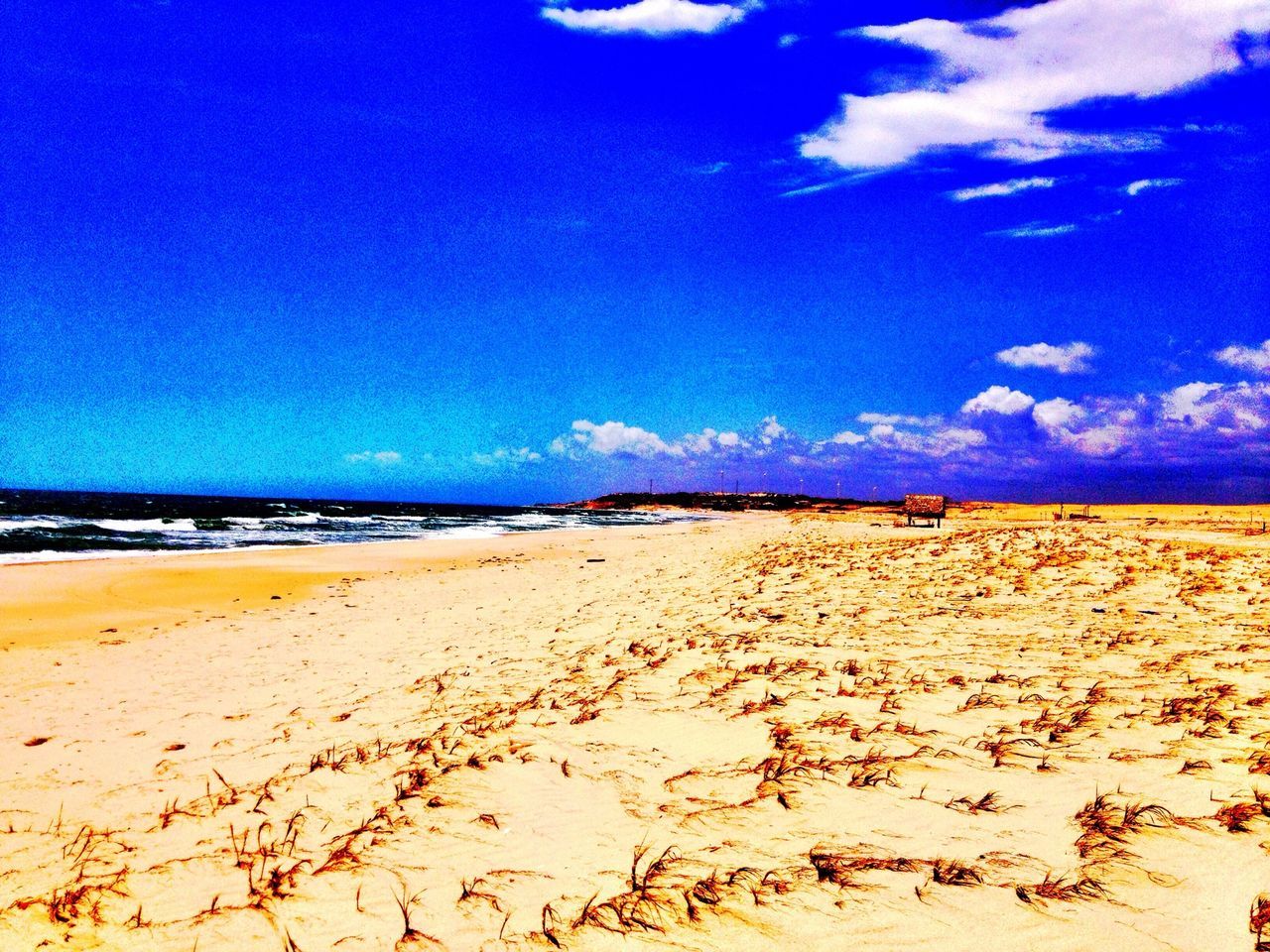 beach, sand, blue, shore, sea, tranquility, tranquil scene, water, scenics, beauty in nature, sky, nature, horizon over water, coastline, idyllic, day, outdoors, footprint, remote, summer