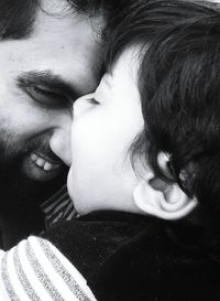 Close-up of happy father and son face to face