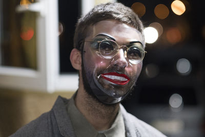 Close-up of man wearing mask at night