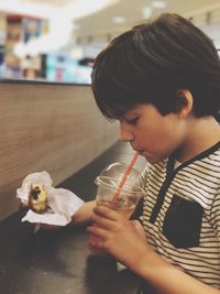 Boy having food and drink at restaurant