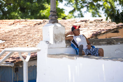 Rear view of woman sitting outdoors