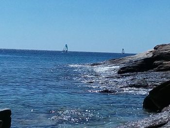 Scenic view of calm sea against clear sky