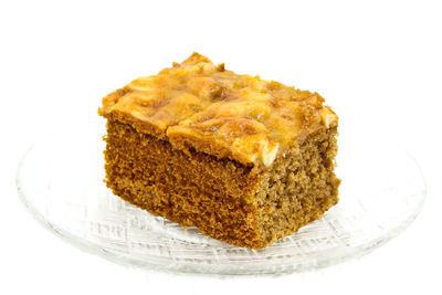 Close-up of cake on plate against white background