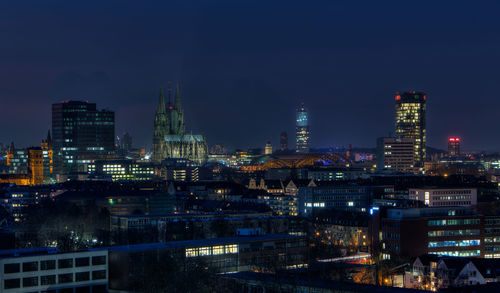 High angle view of illuminated buildings in city at night