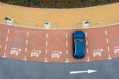 Aerial view directly above  electric vehicle charging station with parking spaces for charging bays