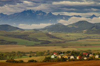 Scenic view of field and mountains against sky