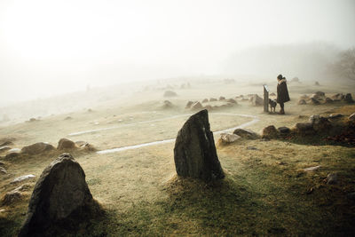 Woman on beach in fog 