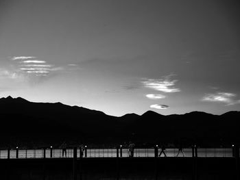 Scenic view of silhouette mountains against sky at sunset