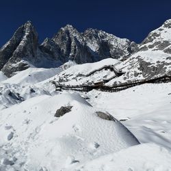 Scenic view of snow covered mountains against sky