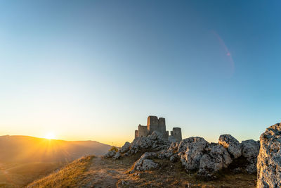 Panoramic view of rocks against sky during sunset