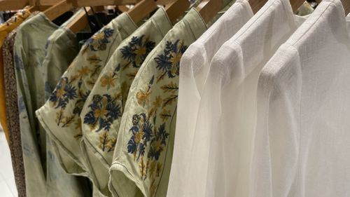 Clothes hanging on rack in store