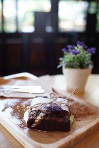 Close-up of brownie wrapped in paper on table