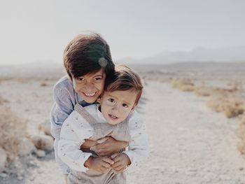 Portrait of two kids hugging in the desert