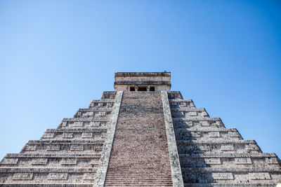 Low angle view of historical building against blue sky