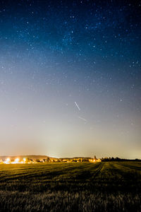 Scenic view of field against sky at night