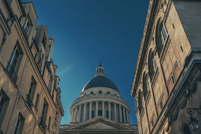 Low angle view of buildings against blue sky