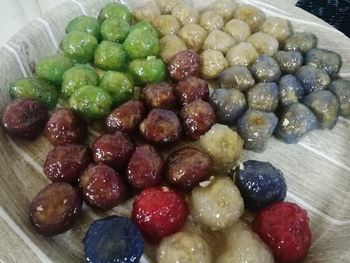 High angle view of grapes in bowl on table