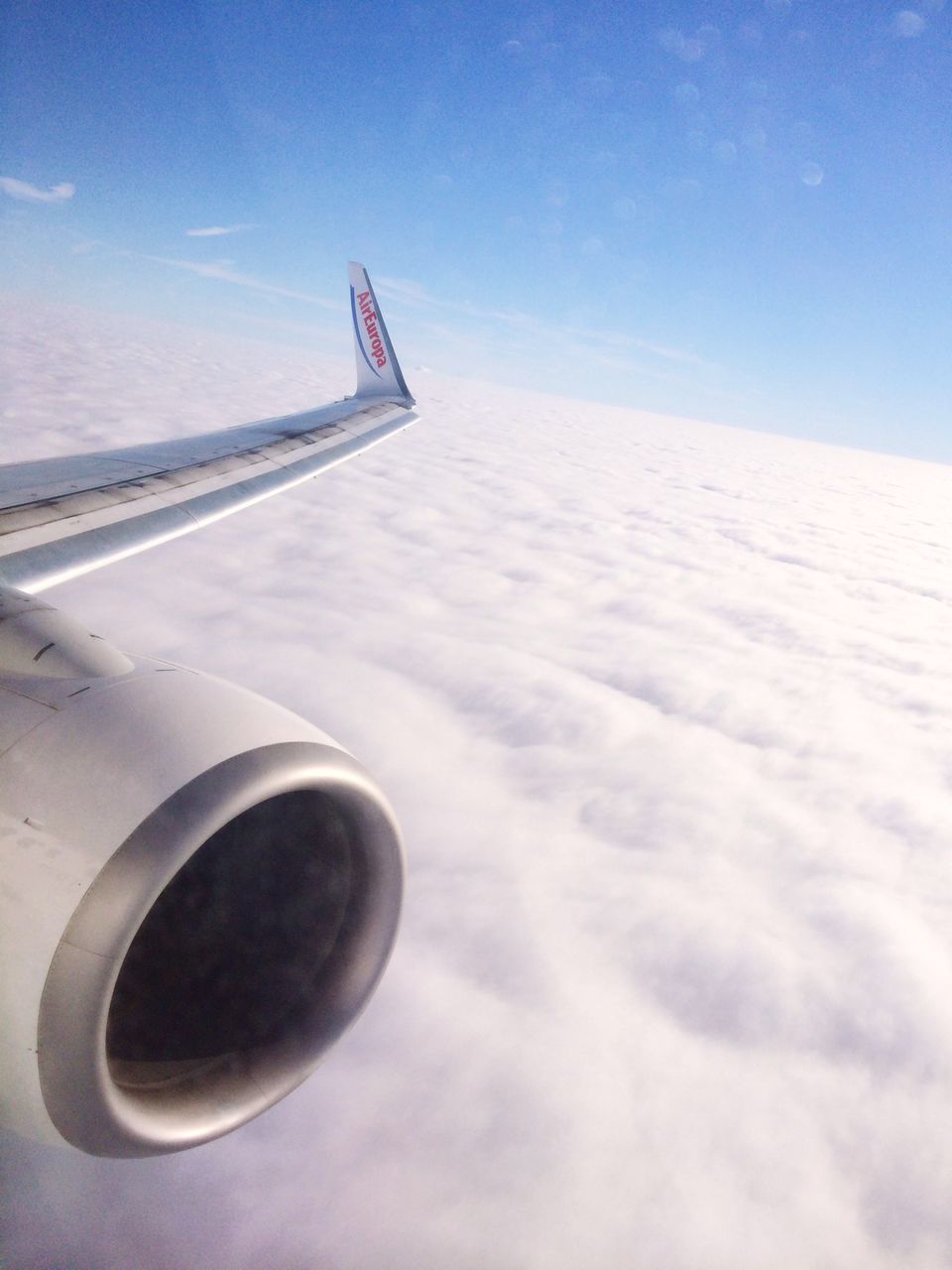 sky, transportation, blue, airplane, white color, day, air vehicle, cropped, guidance, cloud - sky, part of, outdoors, sunlight, no people, cloud, aircraft wing, sea, mode of transport, travel, direction