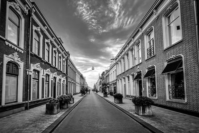 Narrow street amidst buildings against sky