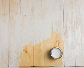 Directly above shot of coffee cup on hardwood floor