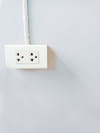 Close-up of electric lamp against wall