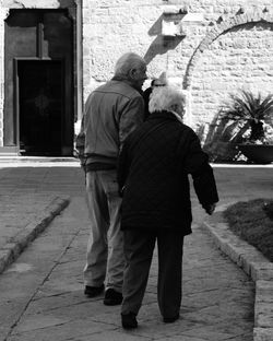 Rear view of couple walking outdoors