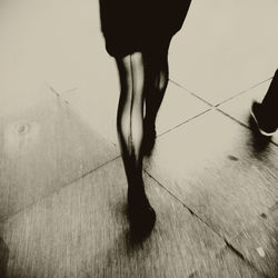 Low section of woman standing on tiled floor