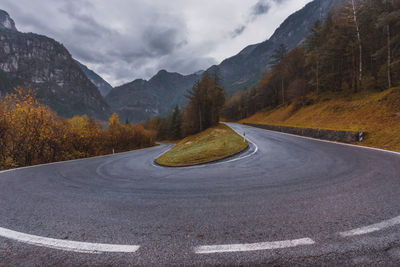 Road amidst mountains against sky