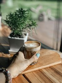 Man holding coffee cup on table