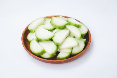 Close-up of fruit salad in bowl against white background