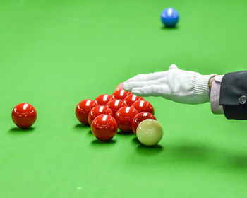 Midsection of person playing with ball on table
