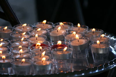 Close-up of lit tea light candles in temple