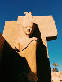 Low angle view of statue against clear blue sky