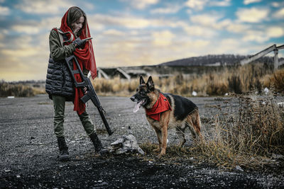 Man with dog standing in snow