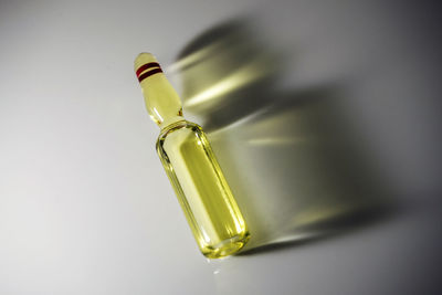 Close-up of green bottle against white background