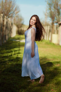 Portrait of a beautiful young woman in field