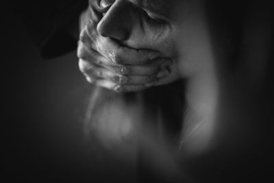 Close-up of man against black background