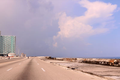 Road by city against sky