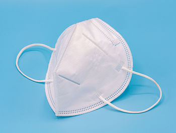 High angle view of eyeglasses on table against blue background