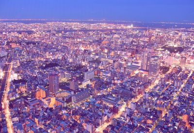 High angle view of illuminated city buildings at night