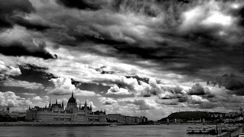 Panoramic view of city against cloudy sky