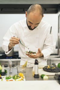 Chef preparing food in commercial kitchen