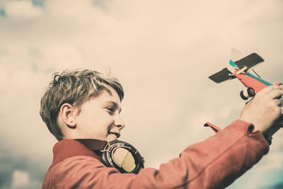 Close-up of boy playing with toy airplane