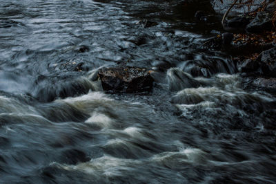 High angle view of water flowing through rocks